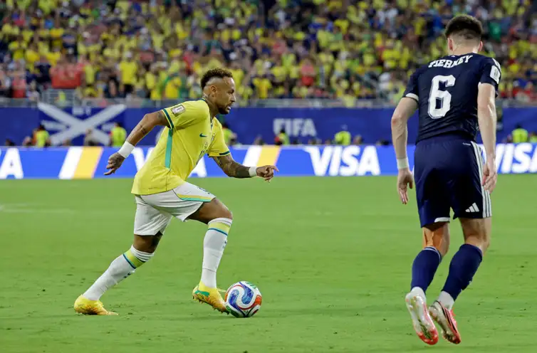 Soccer Football - FIFA World Cup 2026 - Group C - Scotland v Brazil - Miami Stadium, Miami Gardens, Florida, U.S. - June 24, 2026 Brazil's Neymar Jr. in action with Scotland's Kieran Tierney REUTERS/Amanda Perobelli